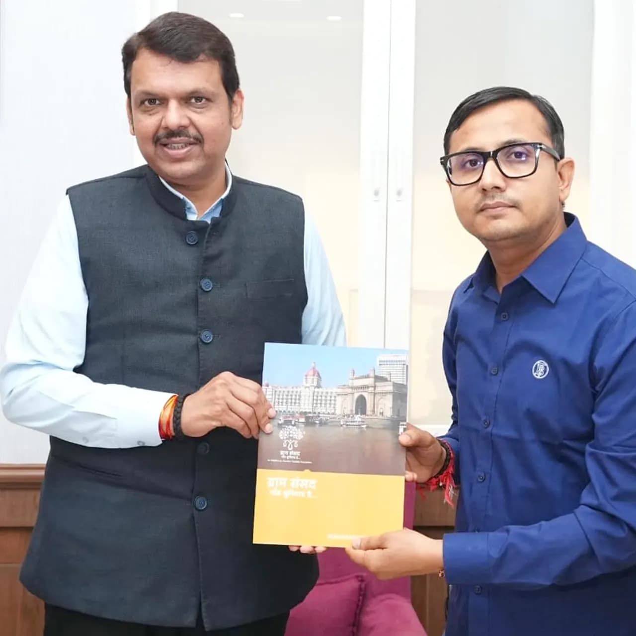 Presenting the Gram Sansad booklet to a dignitary